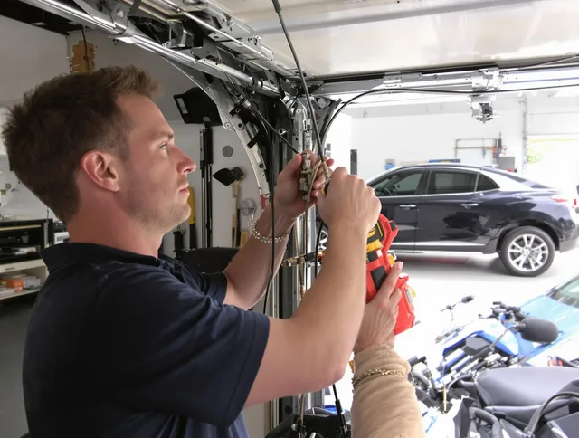 Kissimmee Garage Door Repair safety certified technician performing cable replacement in Kissimmee